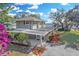 Inviting waterfront home featuring a covered patio, lush landscaping, and serene water views at 3943 Chambers St, Lake Wales, FL 33898