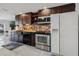 Well-appointed kitchen with stainless steel appliances, dark cabinets, stone backsplash, and ample counter space at 3943 Chambers St, Lake Wales, FL 33898