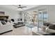 Bright living room with sleek furniture, tile floors, and serene outdoor views at 3943 Chambers St, Lake Wales, FL 33898