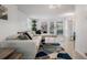 Bright living room with a modern white sectional and colorful area rug at 3943 Chambers St, Lake Wales, FL 33898