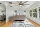 Sunlit main bedroom with views, hardwood floors, ceiling fan, and ample natural light at 3943 Chambers St, Lake Wales, FL 33898