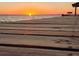 A peaceful sunset view from a wooden dock, capturing the beauty of the waterfront at 3943 Chambers St, Lake Wales, FL 33898