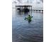 Person kayaking on tranquil waters, featuring a private dock and boat shelter, reflecting the sky and adding to the scene's beauty at 3943 Chambers St, Lake Wales, FL 33898