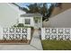 A welcoming entrance to a single-story home, featuring a decorative privacy wall and tidy landscaping at 407 San Jose Dr, Winter Haven, FL 33884