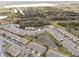 Overhead shot of multiple townhomes in a neighborhood with ponds and dense tree coverage at 4084 Winding Vine Dr, Lakeland, FL 33812