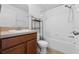 Bathroom featuring tiled shower, a vanity and a commode in a compact space at 4084 Winding Vine Dr, Lakeland, FL 33812