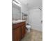 Bathroom featuring tiled shower, a vanity and a commode in a compact space at 4084 Winding Vine Dr, Lakeland, FL 33812