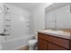 A bathroom features a shower and tub combination, a vanity, and a commode at 4084 Winding Vine Dr, Lakeland, FL 33812