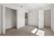 A bright bedroom boasts neutral carpeting, white walls, and two closet spaces at 4084 Winding Vine Dr, Lakeland, FL 33812