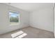 Empty bedroom with light carpet, neutral walls and a view to the outside at 4084 Winding Vine Dr, Lakeland, FL 33812