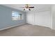 Bedroom with a large window for natural light, blue wall and neutral carpet at 4084 Winding Vine Dr, Lakeland, FL 33812
