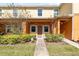 Charming two-story townhome featuring a well-maintained lawn and inviting front porch entrance at 4084 Winding Vine Dr, Lakeland, FL 33812