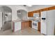 Functional kitchen featuring wood cabinets, white appliances, and ample counter space at 4084 Winding Vine Dr, Lakeland, FL 33812