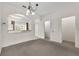 Bright living area with a large window, open doorway, and neutral-colored walls and carpet at 4084 Winding Vine Dr, Lakeland, FL 33812
