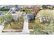 Aerial view of a single Gathering home with a long driveway, mature trees, and a neatly maintained front lawn at 433 Carleton St, Lakeland, FL 33803