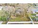 Aerial shot of a grassy backyard enclosed by a white fence, and mature trees, offering a sense of privacy at 433 Carleton St, Lakeland, FL 33803