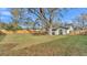 Large, well-maintained backyard featuring a lawn, mature tree, and privacy fence at 433 Carleton St, Lakeland, FL 33803
