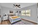 Bright bedroom with a ceiling fan, area rug, natural light from a large window, and neutral decor at 433 Carleton St, Lakeland, FL 33803