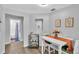 Cozy dining area with white table, modern decor, and access to a full bathroom at 433 Carleton St, Lakeland, FL 33803