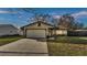 Charming single-story home features a well-manicured front yard and attached garage at 433 Carleton St, Lakeland, FL 33803