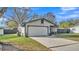 Charming single-Gathering home with a white garage door and a well-kept lawn and driveway at 433 Carleton St, Lakeland, FL 33803