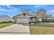 Well-maintained single story home with attached two car garage and beautifully landscaped front yard at 433 Carleton St, Lakeland, FL 33803