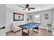 Game room with a blue pool table, a sofa, and a window, perfect for entertainment and relaxation at 433 Carleton St, Lakeland, FL 33803
