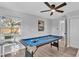 Game room featuring a pool table, a ceiling fan, and a view from the window, ideal for leisure activities at 433 Carleton St, Lakeland, FL 33803