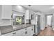 Updated kitchen features granite countertops, stainless steel appliances, and stylish white cabinetry at 433 Carleton St, Lakeland, FL 33803