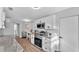 Modern kitchen features white cabinets, stainless steel appliances, granite countertops, and wood-look flooring at 433 Carleton St, Lakeland, FL 33803