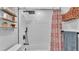 Stylish shower area featuring white subway tiles, modern fixtures, and a patterned shower curtain for added privacy at 433 Carleton St, Lakeland, FL 33803