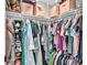 Organized walk-in closet featuring shelving, hanging rods, and storage boxes for efficient storage solutions at 433 Carleton St, Lakeland, FL 33803
