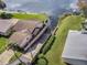 An aerial view of a home with direct waterfront access, featuring a private boat slip, and lush landscaping at 4422 Glenns Lndg, Winter Haven, FL 33884