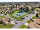 An aerial view of a community tennis court with a parking lot surrounded by well-maintained lawns and mature trees at 4422 Glenns Lndg, Winter Haven, FL 33884