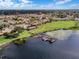 Aerial shot of a community with lake access, featuring a clubhouse, swimming pool, and boat docks for recreational enjoyment at 4422 Glenns Lndg, Winter Haven, FL 33884