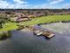 Aerial shot of a community with lake access, featuring a clubhouse, swimming pool, and boat docks for recreational enjoyment at 4422 Glenns Lndg, Winter Haven, FL 33884