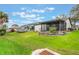 Spacious backyard featuring a screened lanai, wood deck, and well-maintained lawn at 4422 Glenns Lndg, Winter Haven, FL 33884