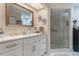 Bathroom with a large framed mirror and an enclosed glass door shower at 4422 Glenns Lndg, Winter Haven, FL 33884
