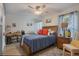 A tidy bedroom with tile flooring, a ceiling fan, and natural light from the windows at 4422 Glenns Lndg, Winter Haven, FL 33884