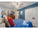 Comfortable bedroom with blue walls, wood dresser, a large bed and a closet at 4422 Glenns Lndg, Winter Haven, FL 33884