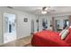 Bright bedroom with a red comforter set and an open door to the bathroom at 4422 Glenns Lndg, Winter Haven, FL 33884