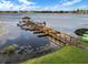 Community boat dock on a serene lake featuring boat slips, a charming gazebo, and easy access for kayaks and boats at 4422 Glenns Lndg, Winter Haven, FL 33884