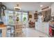 Cozy dining area with large windows, white tiled floors, and adjacent to the kitchen at 4422 Glenns Lndg, Winter Haven, FL 33884