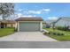 Attached two-car garage with a concrete driveway and well-maintained landscaping at 4422 Glenns Lndg, Winter Haven, FL 33884