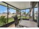 A screened patio featuring outdoor seating and a view of the fenced backyard at 4422 Glenns Lndg, Winter Haven, FL 33884