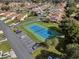 A tennis court in a residential neighborhood featuring ample parking and meticulously maintained landscaping, creating a recreational atmosphere at 4422 Glenns Lndg, Winter Haven, FL 33884