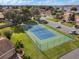 A well-maintained tennis court offers a recreational space with manicured green lawns and a community parking area for residents at 4422 Glenns Lndg, Winter Haven, FL 33884