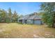 The rear exterior of the house showcases a screened porch and well-maintained landscaping at 4556 Hancock Lake Rd, Lakeland, FL 33812