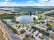 Community aerial showcasing lush landscaping and a tranquil lake for the enjoyment of homeowners at 496 Lake Suzanne Dr, Lake Wales, FL 33859