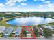 Wide aerial shot showcasing the house with waterfront view and surrounding neighborhood at 496 Lake Suzanne Dr, Lake Wales, FL 33859